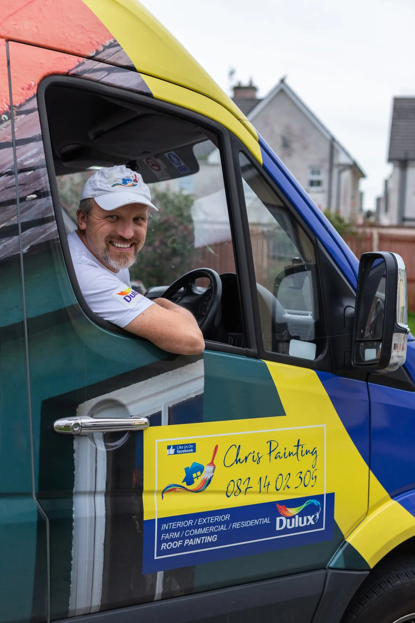 Chris smiling from the driver's seat of the Chris Painting van