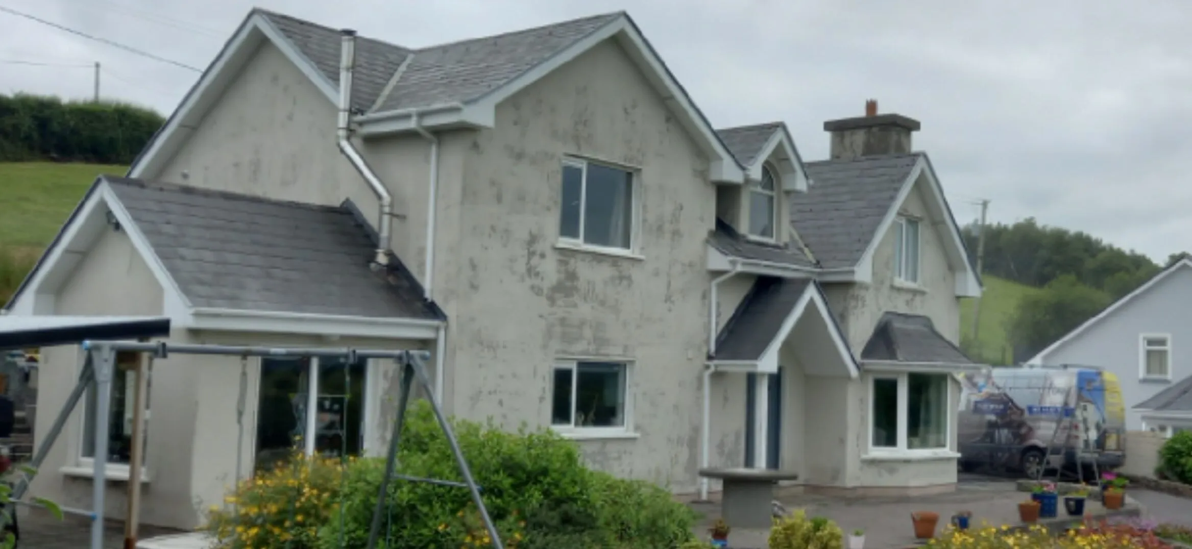 House with grey render before painting