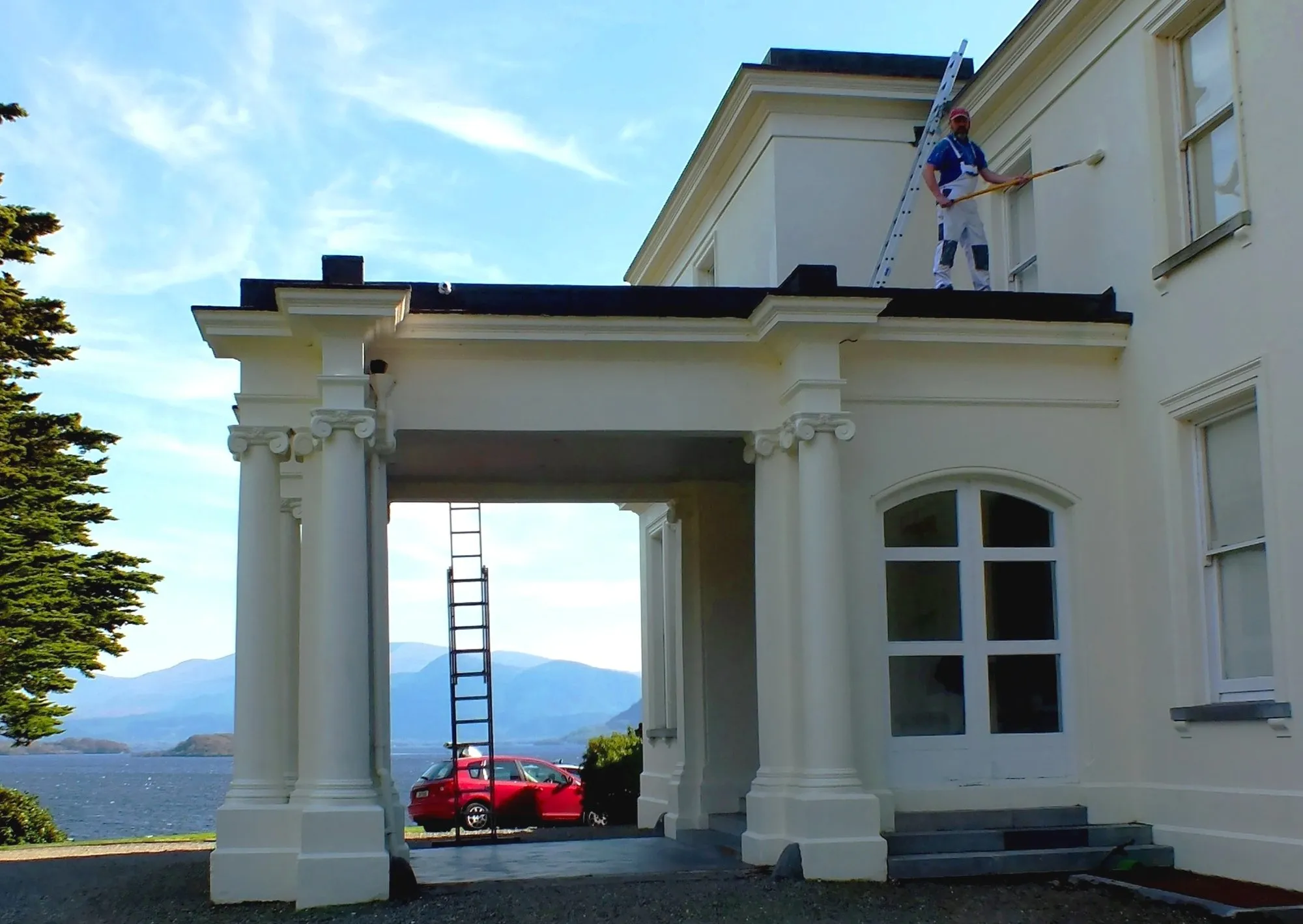 Painter working on top of a columned portico